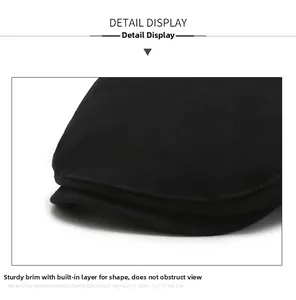 Detail of a black flat cap showing the reinforced brim and neat stitching on twill cotton