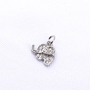 Detail view of silver elephant pendant with micro-pave cubic zirconia on textured fabric