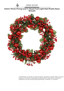 Detail of Christmas wreath featuring red berries, glossy balls and green faux leaves