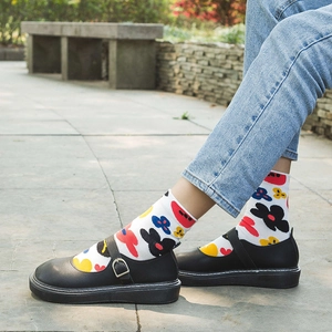 Casual mid-calf cotton socks with colorful floral patterns and Mary Jane shoes