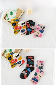Close-up of knit cotton crew socks featuring colorful abstract floral print patterns