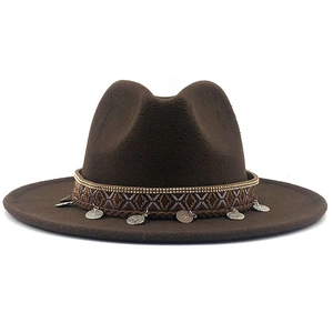 Detail of dark brown wool fedora hat with ethnic woven band and silver coin pendants