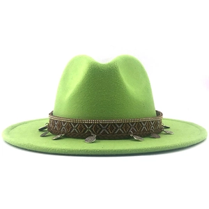 Close-up of bohemian hat band with golden beads and vintage silver leaf pendants