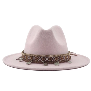 Close-up of pink fedora hat with bohemian ethnic ribbon and hanging silver coin charms