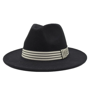 Detail of vintage black wool fedora hat featuring a stylish striped grosgrain ribbon trim