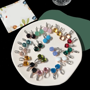 Detailed macro of S925 silver hoop earrings with colorful sugar-loaf crystal pendants