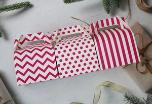 Pink paper pastry gift boxes with stripes and dots patterns for festive baking packaging
