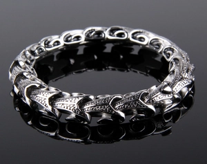 Detailed view of punk dragon bone titanium steel bracelet with vintage silver texture