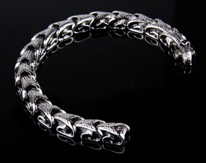 Close-up of vintage punk dragon bone chain bracelet in polished silver stainless steel