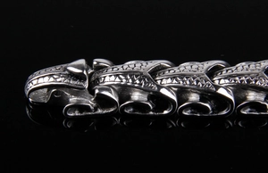 Macro shot of silver dragon scale textured titanium steel bracelet with punk link details