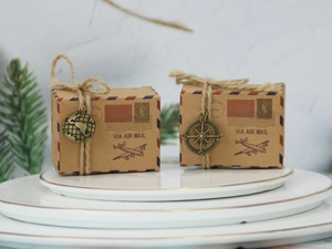 Detail of vintage kraft paper candy boxes with air mail theme and compass charms