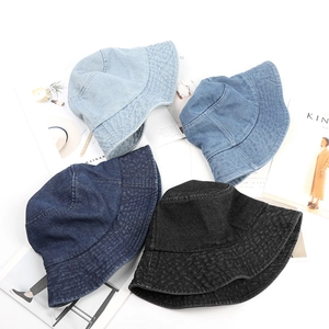 Flat lay of retro denim bucket hats in four colors with wide brims for sun protection