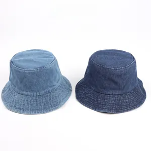 Close-up of vintage washed denim bucket hats in light and dark blue with reinforced stitching
