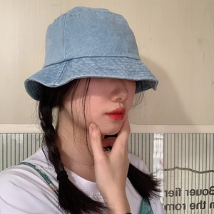 Woman wearing a light blue denim sun hat with a wide brim for outdoor sun protection