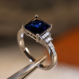Macro shot of a square blue zircon ring featuring a four-prong setting and side diamonds