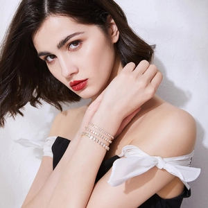 Three-layer gold-plated brass bracelet with sparkling cubic zirconia on female model