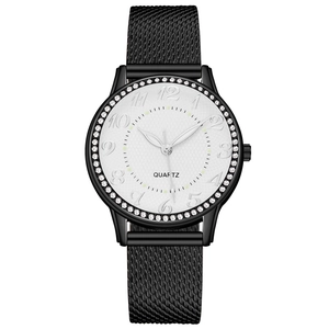 Detailed close-up of quartz watch with diamond bezel and black mesh strap on white dial