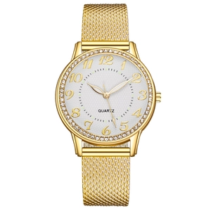 Detailed close-up of a women's gold quartz watch with a diamond-set bezel and mesh strap