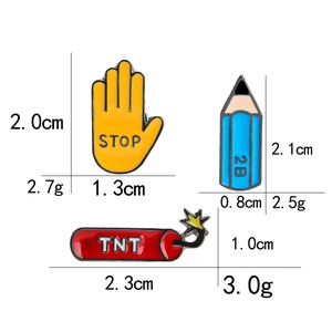 Cartoon enamel pin set with yellow stop hand, blue pencil, and red TNT designs