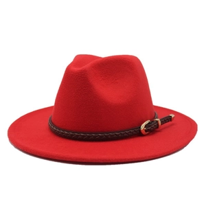 Detail of red wool fedora hat with brown braided leather band and gold buckle accent