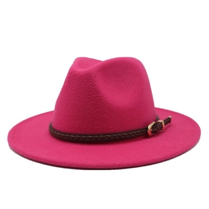 Close-up of rose pink wool fedora hat featuring a braided brown leather band and gold buckle