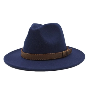 Detail of navy wool jazz hat featuring a brown leather decorative band with fine stitching