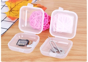 Transparent mini plastic organizers holding SIM cards and needles in a 45-degree angle view