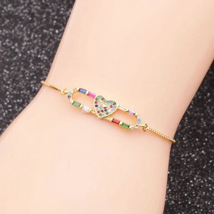 Close-up of adjustable gold heart bracelet with multicolor pavé crystals on wrist