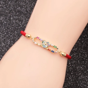 Adjustable red rope bracelet with a gold-plated heart center and multicolored zircons
