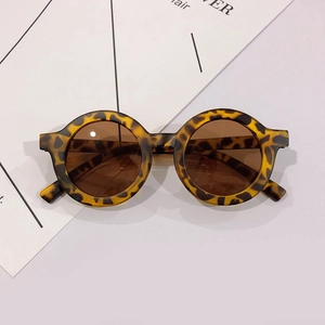 Detail view of round leopard print children's glasses frames with dark brown lenses