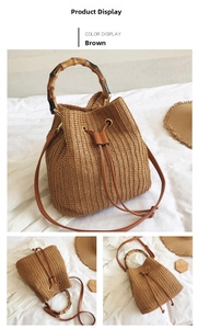 Detailed view of straw bucket bag featuring a natural bamboo handle and drawstring closure