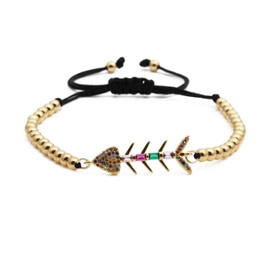 Adjustable copper bracelet featuring a gold-plated fish bone pendant with colorful zircon