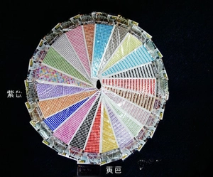 Macro shot of 3mm acrylic gemstone stickers in various colors for DIY diamond art crafts