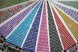Macro detail of multi-colored 3mm acrylic self-adhesive rhinestone sheets for DIY crafts
