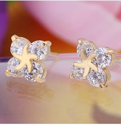 Close-up of 18K gold plated flower stud earrings with sparkling clear cubic zirconia