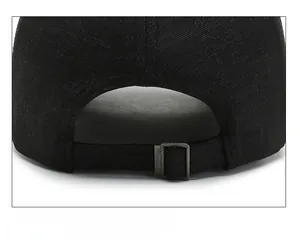 Detail view of the adjustable metal buckle strap on a black cotton baseball cap