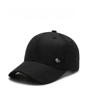 Detail of a black casual baseball cap featuring a premium silver metal logo on the side