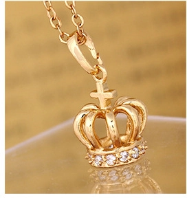 Macro view of 18K gold plated crown pendant with cross and white zircon stones