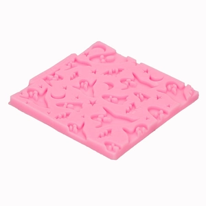 Pink silicone Halloween mold with ghosts, bats, and moon shapes for DIY cake baking