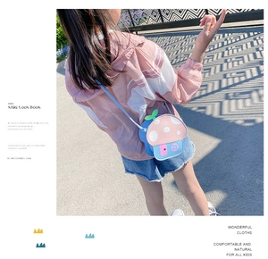 Chic blue and pink mushroom shaped cross body bag shown in an outdoor lifestyle setting