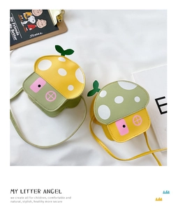 Detail of mushroom house shaped kids purses in yellow and green PU leather