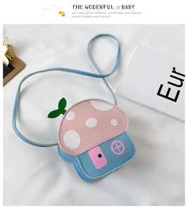 Detail of cute mushroom house shaped kids crossbody bag in pink and sky blue colors