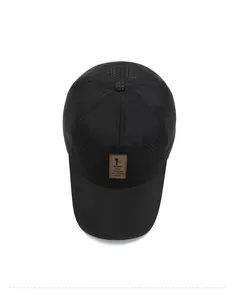 Top view of black quick-dry baseball cap showing breathable laser-cut holes and leather patch