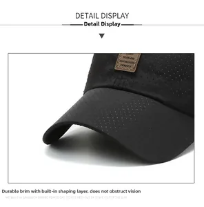 Detail of breathable mesh fabric and brown leather label on black baseball cap