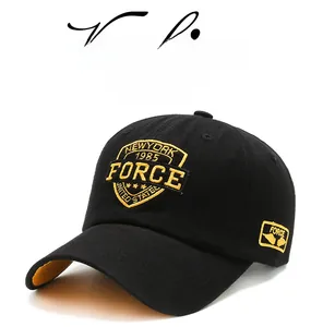 Close-up of a black baseball cap featuring yellow 3D embroidery and twill cotton texture