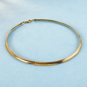 Minimalist gold-plated stainless steel snake chain necklace on a light blue background
