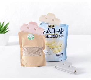 Three colorful plastic bag clips sealing snacks in a bright kitchen setting