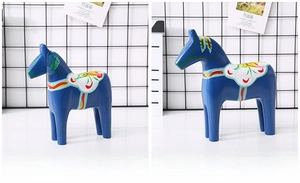 Blue Swedish Dala Horse figurines in two sizes featuring vibrant floral painted patterns
