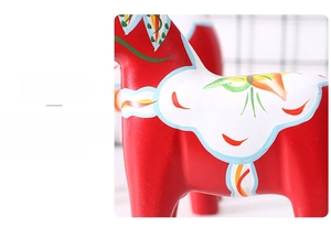 Macro shot of colorful hand-painted patterns on a red wooden Dala Horse decoration