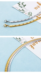 Detail of gold and silver snake chain necklaces with engraved cross patterns